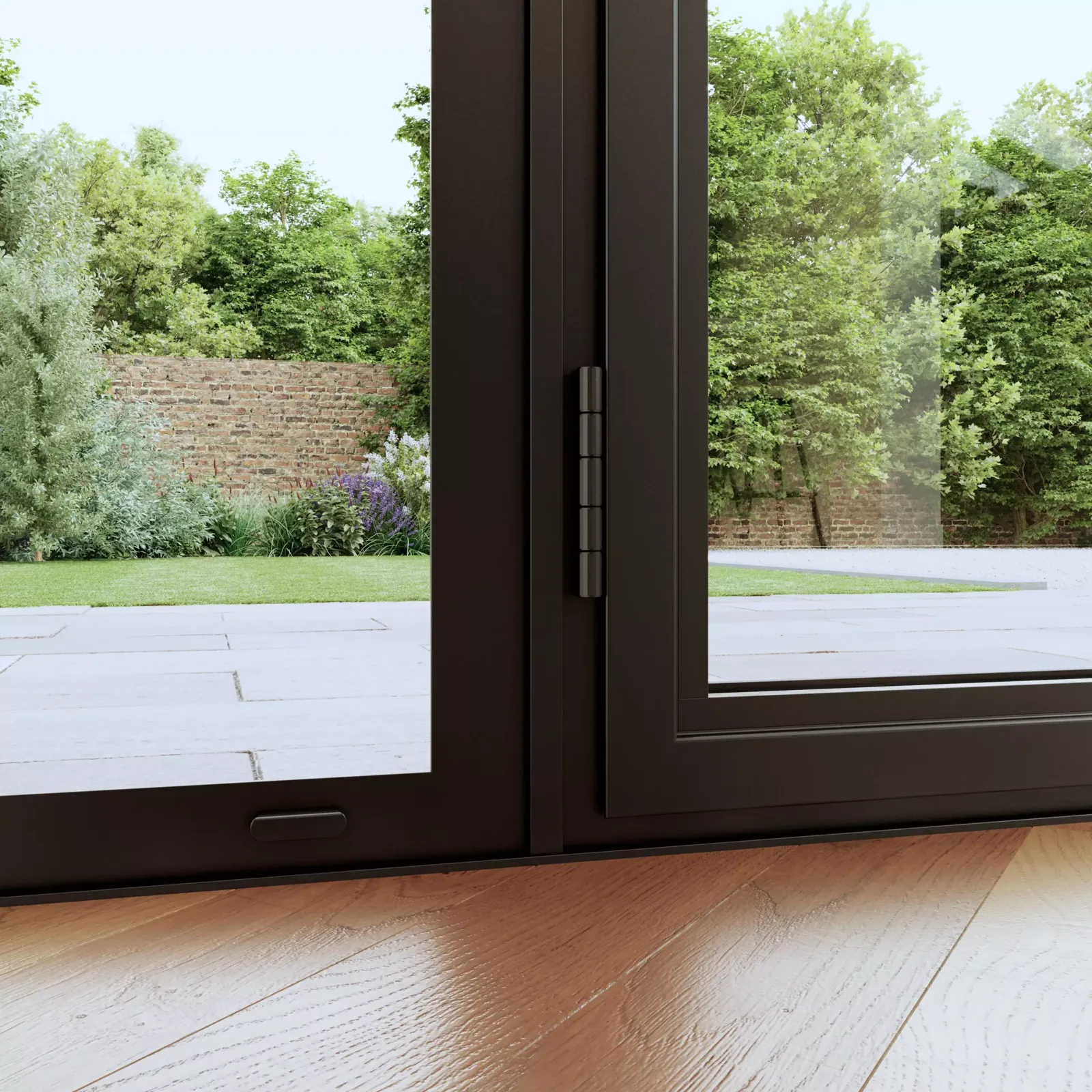 Heritage door threshold, Chichester Low door threshold and hinge detail on a black frame, opening onto a garden