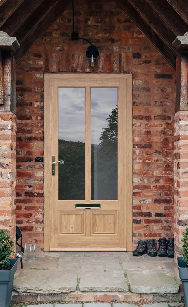 Timber-look front doors in Chichester Oak timber-look front door with two glazed panels in a brick porch