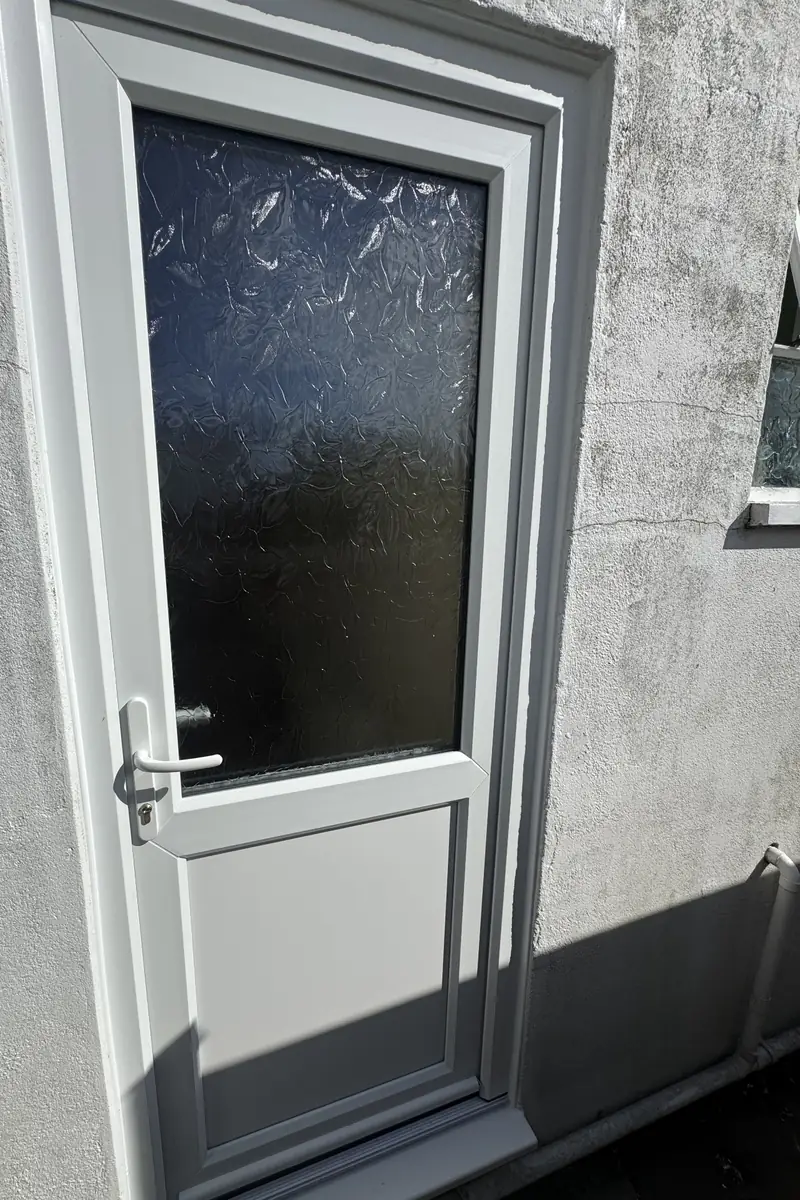 White uPVC half-glazed back door with obscure glass after installation in Chichester